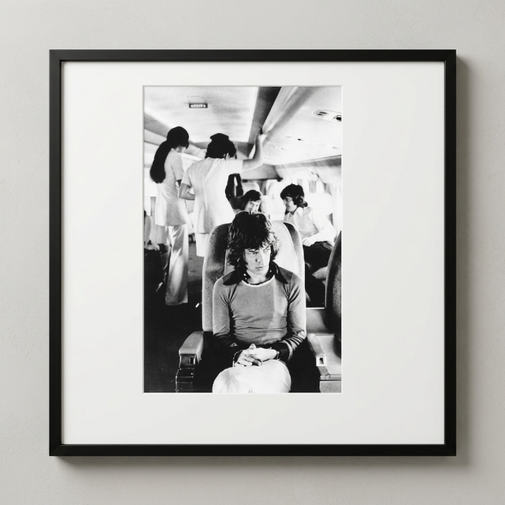 Mick Jagger On Tour Plane (1972) — Jim Marshall — Framed Print